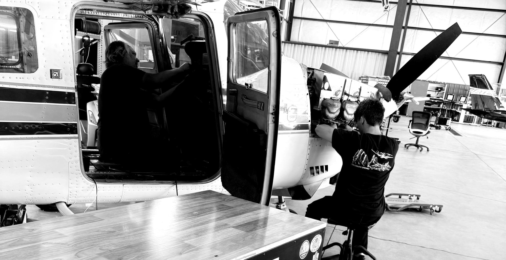 Two technicians working a Cessna single on the Colorado Springs hangar floor