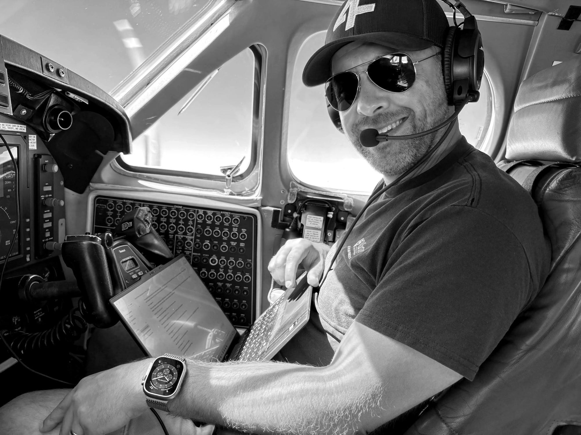 Greg Wellman, Fourth Front co-founder, in the cockpit wearing a 4F cap and headset