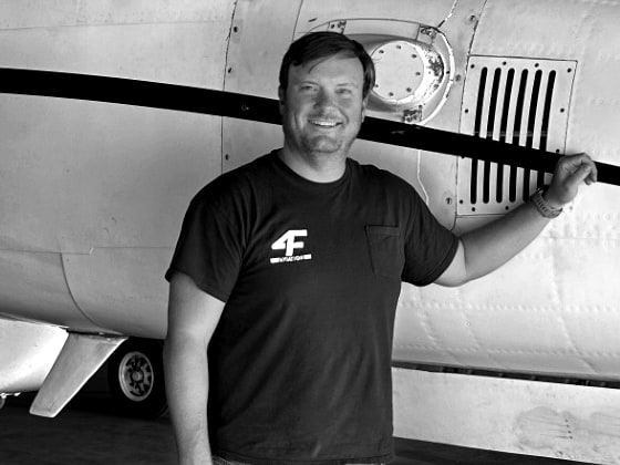 Tom Schaefer, Fourth Front co-founder, beside a twin turboprop in the hangar