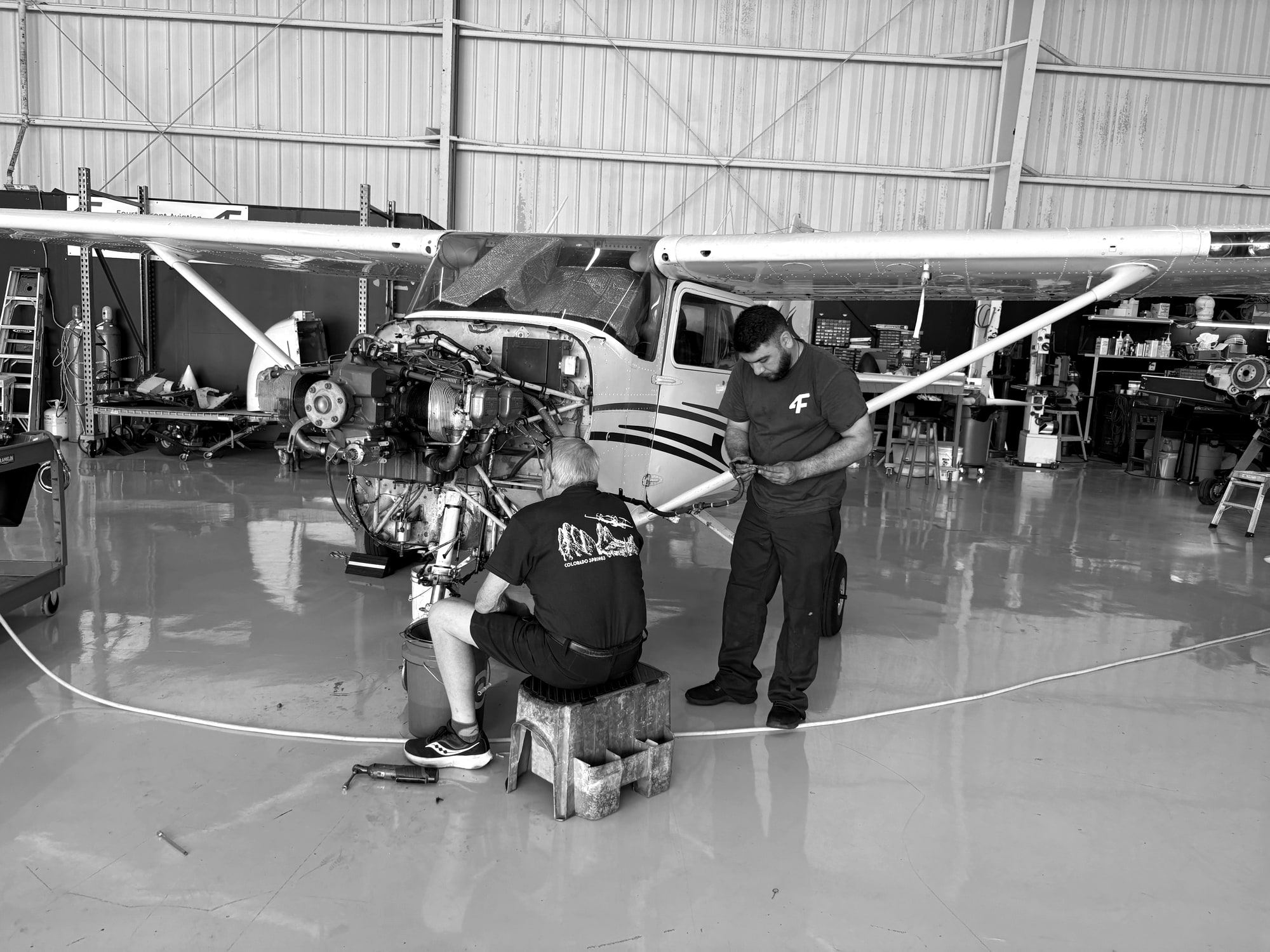 Fourth Front technicians working on the engine of a Cessna single in Hangar 1