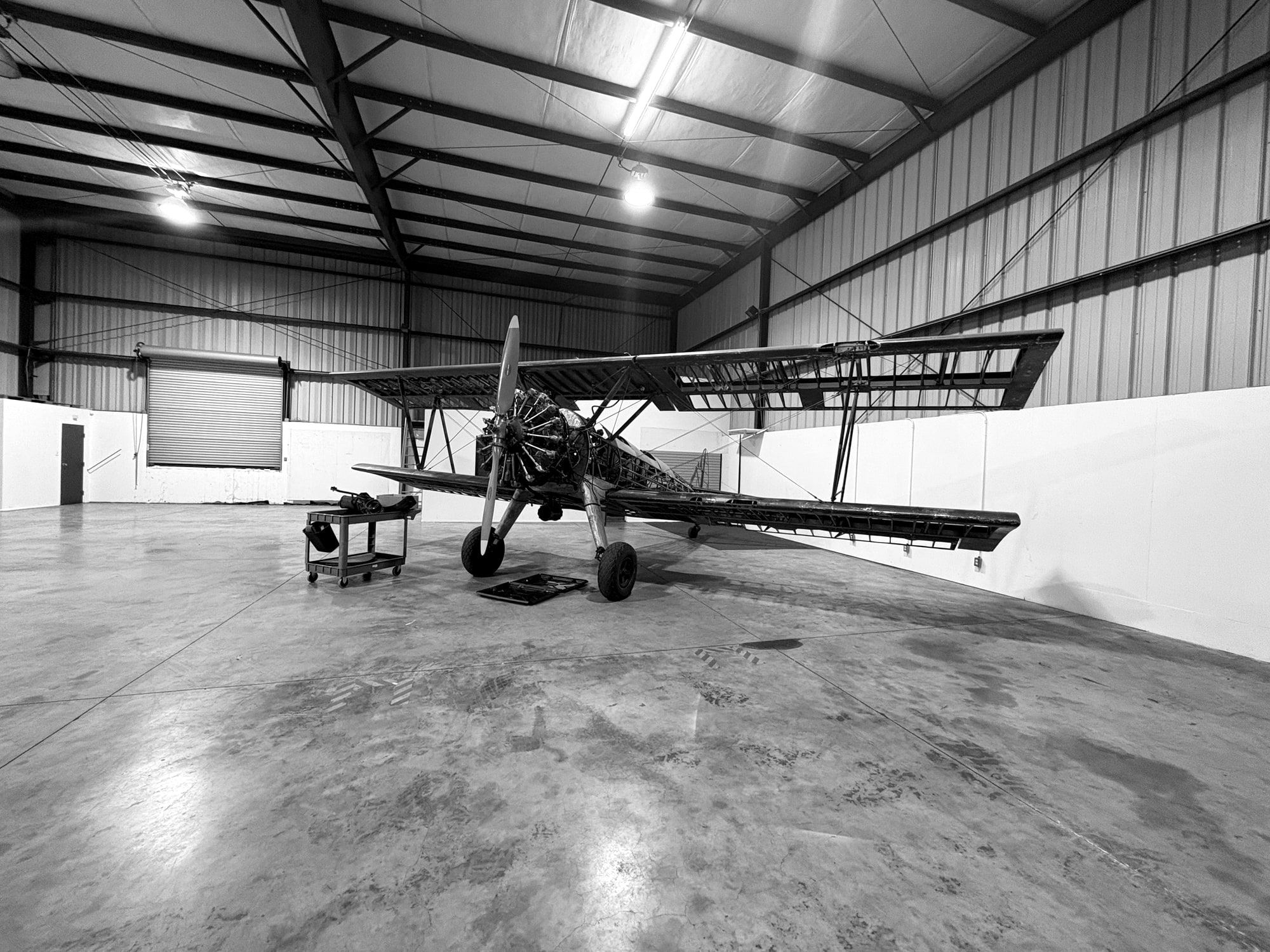 Stearman biplane with its fabric off in the Fourth Front hangar